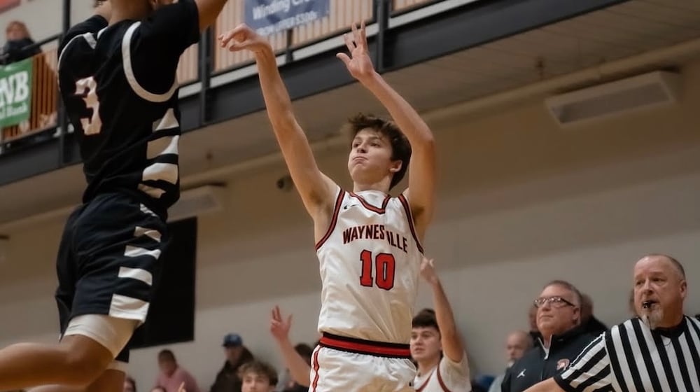 Waynesville coach Brandon Philpot (right) watches as junior Ross Barrett fires up a shot during a recent game. CARSON HALE / CONTRIBUTED
