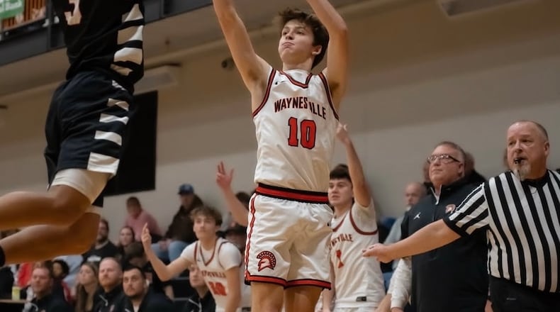 Waynesville coach Brandon Philpot (right) watches as junior Ross Barrett fires up a shot during a recent game. CARSON HALE / CONTRIBUTED