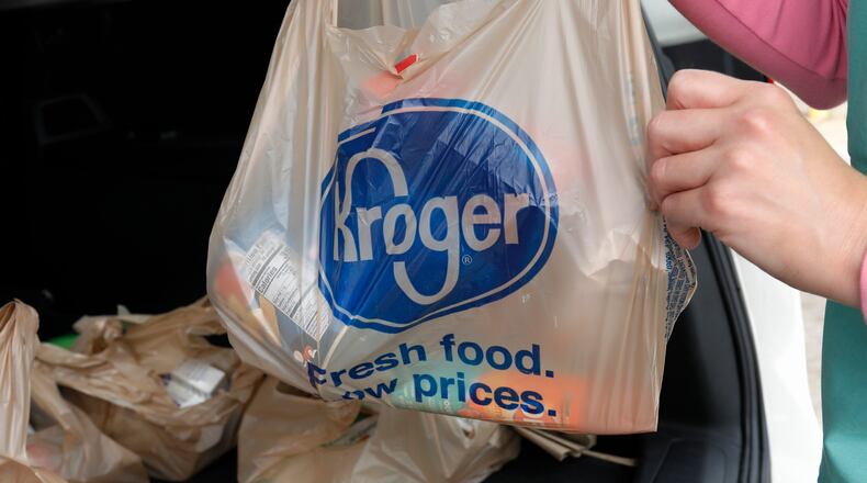 FILE - A customer removes her purchases at a Kroger grocery store in Flowood, Miss., Wednesday, June 26, 2019. Kroger and Albertsons are selling more than 400 stores and other assets to C&S Wholesale Grocers in an approximately $1.9 billion deal as part of their efforts to complete their merger, Friday, Sept. 8, 2023. (AP Photo/Rogelio V. Solis, File)
