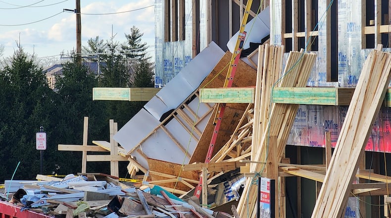 One exterior framed wall of a three-story apartment building on Liberty Way in West Chester Twp. collapsed at around 3 p.m. Jan. 17, 2023, briefly trapping a worker. NICK GRAHAM/STAFF