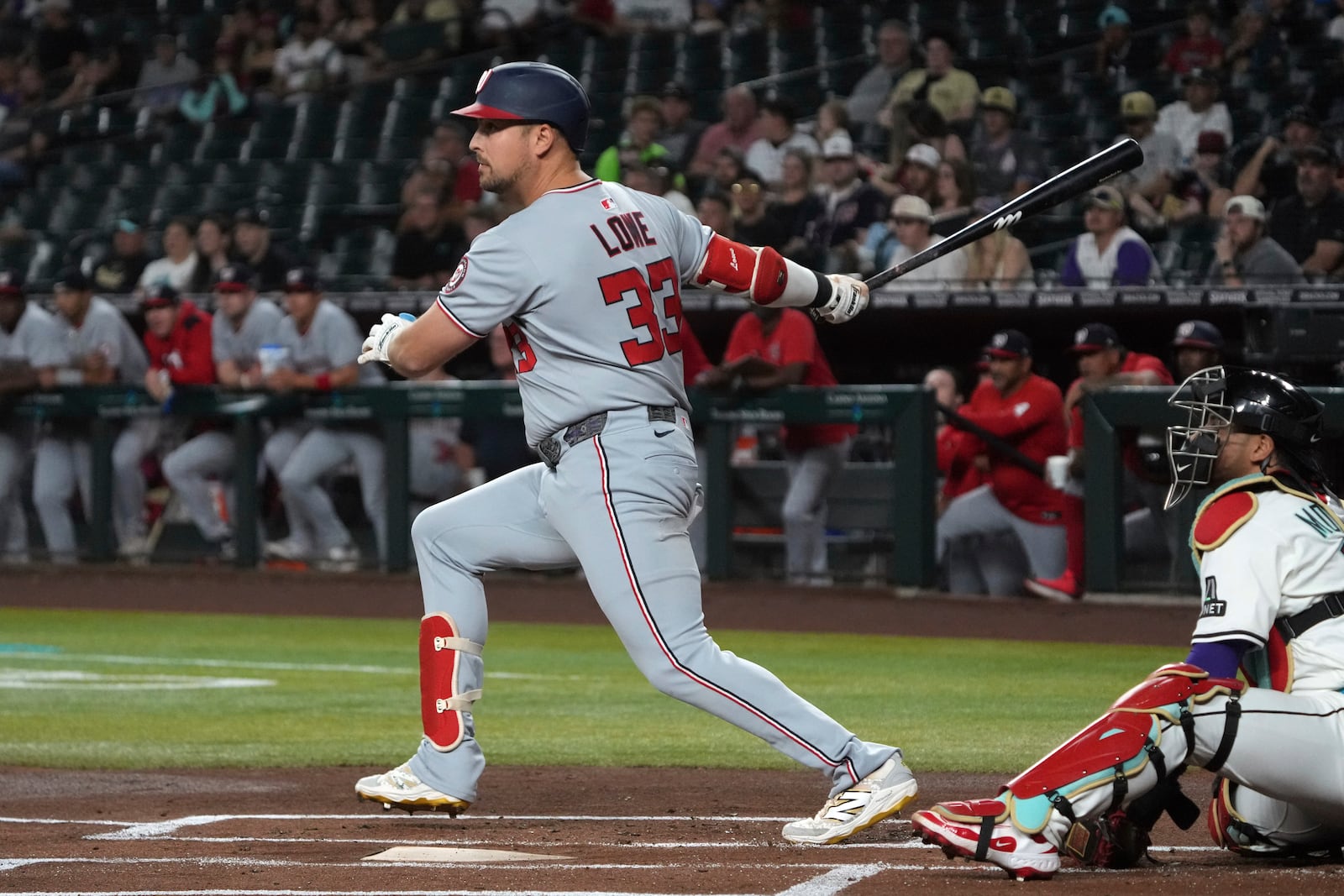 Washington Nationals' Nathaniel Lowe hits an RBI double against the Arizona Diamondbacks in the first inning during a baseball game, Saturday, May 31, 2025, in Phoenix. (AP Photo/Rick Scuteri)