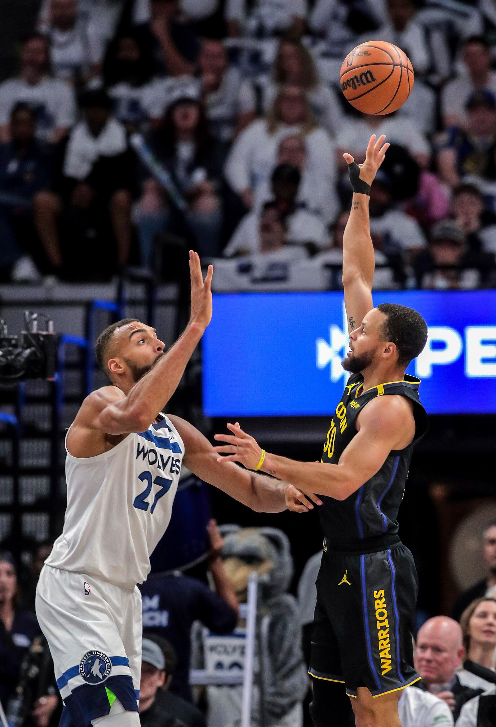 Stephen Curry (30) shoots over Rudy Gobert (27) in the first half as the Golden State Warriors played the Minnesota Timberwolves in Game 1 of the Second Round of the NBA Playoffs at Target Center in Minneapolis, Minn., on Tuesday, May 6, 2025. ( Carlos Avila Gonzalez/San Francisco Chronicle via AP)