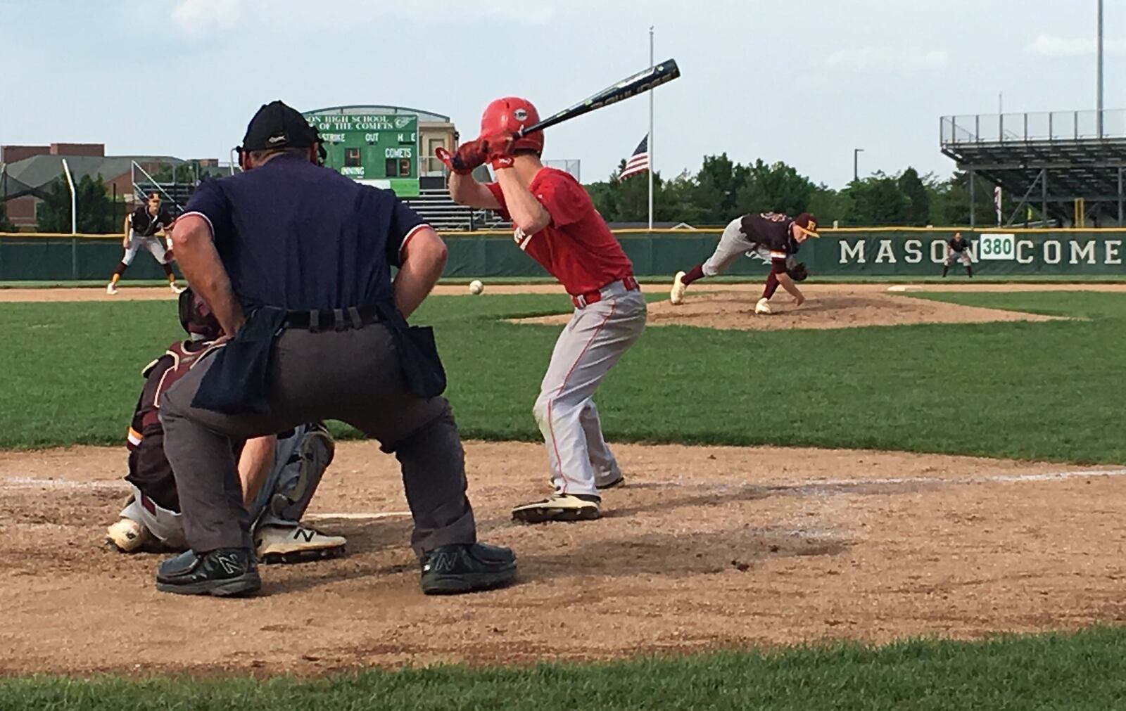 Ross pitcher Paul Schroeder delivers the ball toward Tippecanoe’s Miles McClurg (4) and RHS catcher Andrew Beebe during Monday’s Division II district final at Mason. RICK CASSANO/STAFF