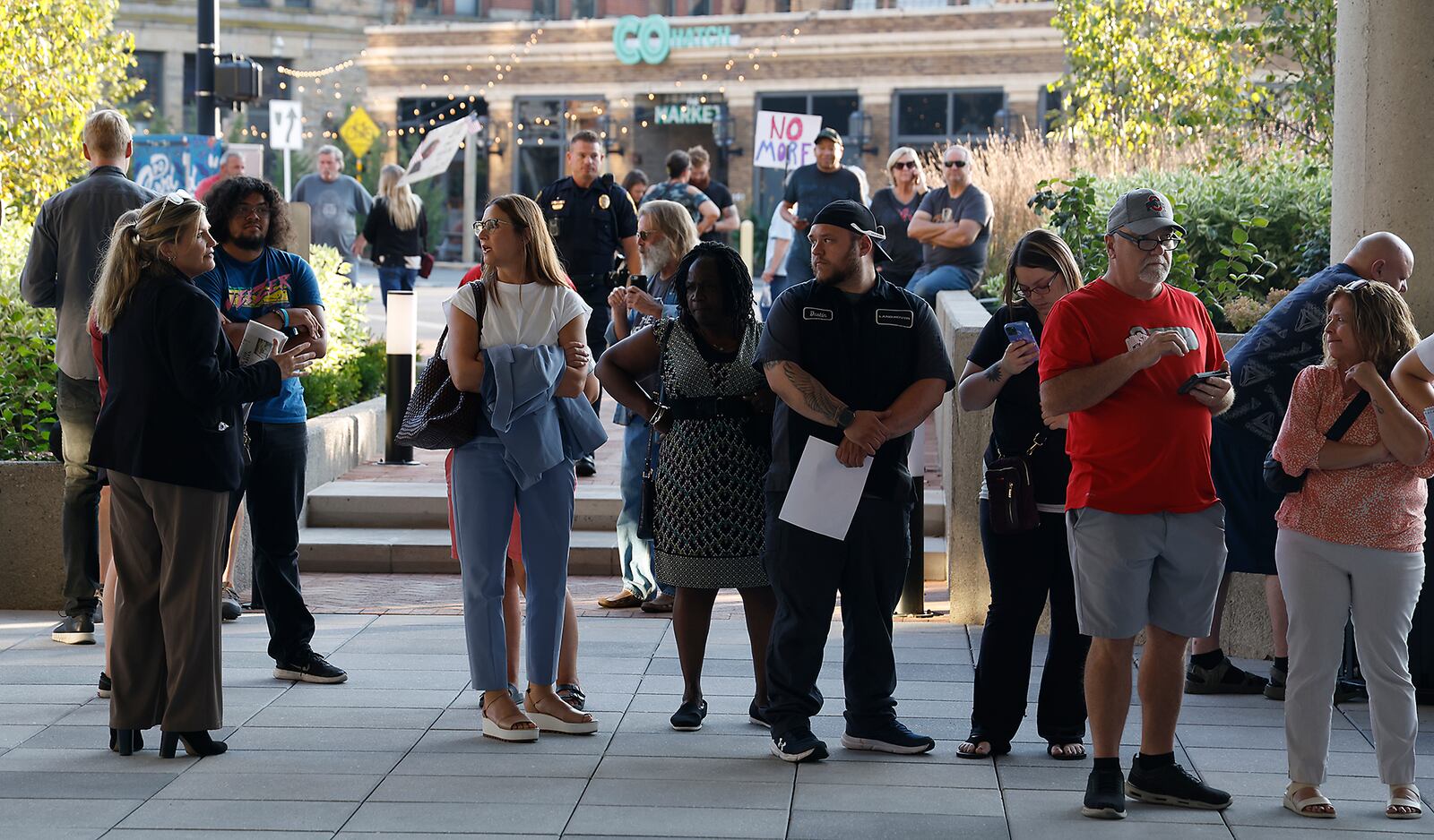 A crowd of people wait outside the Springfield City Commission Meeting, unable to get inside because capacity had been reached in the City Hall Forum Tuesday, Sept. 10, 2024. BILL LACKEY/STAFF