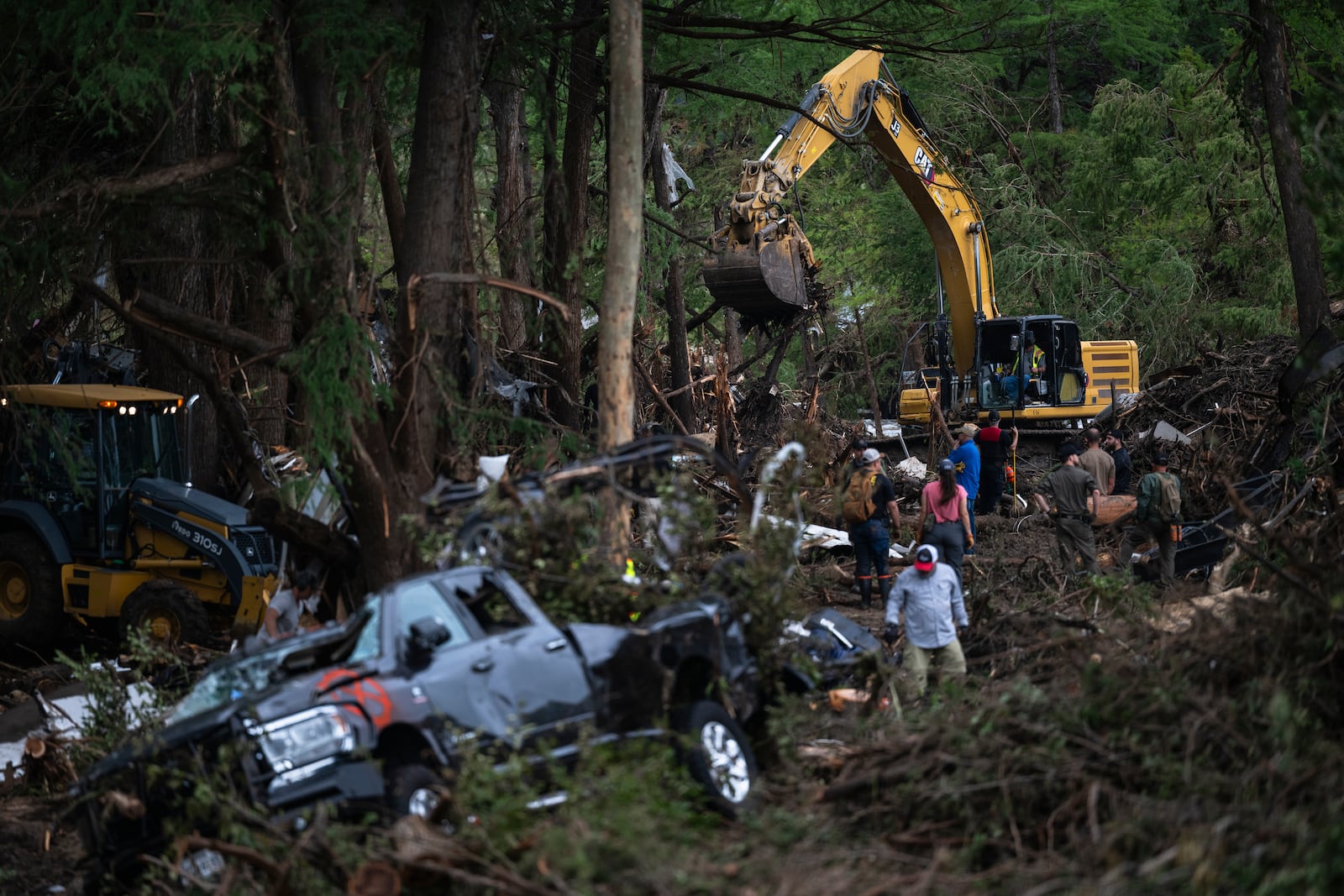 First responders carry out search and rescue operations near the Guadalupe River after a flash flood swept through the area, Monday, July 7, 2025, in Ingram, Texas. (AP Photo/Eli Hartman)
