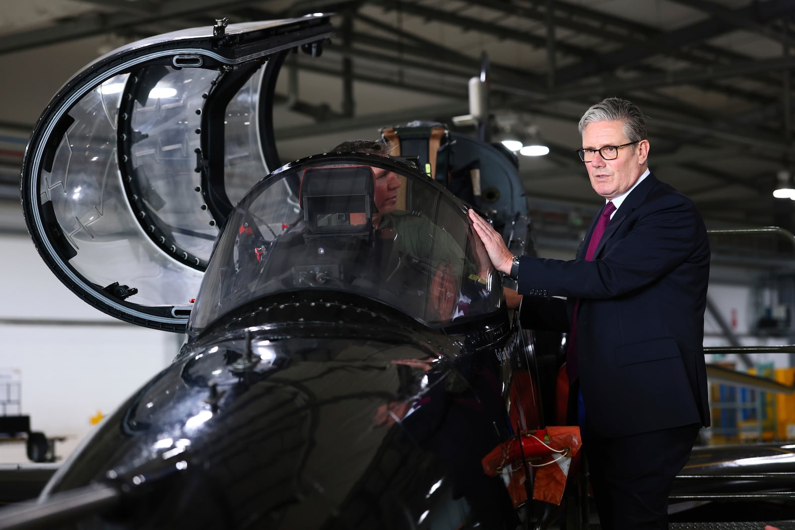 Britain's Prime Minister Keir Starmer is shown a Hawk T2, the RAF's premier fast jet trainer during a visit to RAF Valley, Anglesey, north Wales, Friday June 27, 2025. (Paul Currie/Pool via AP)