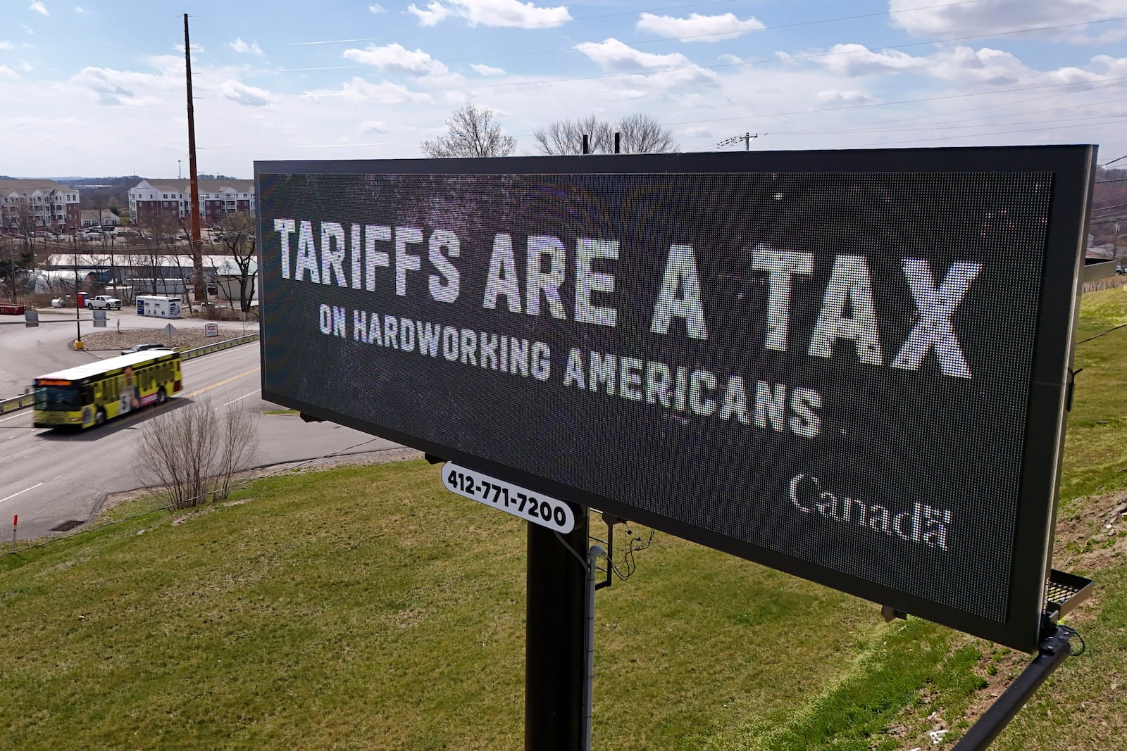 FILE - A digital bill board flashes a tariffs message in Kennedy Township, Pa., Tuesday, March 25, 2025. (AP Photo/Gene J. Puskar, file)
