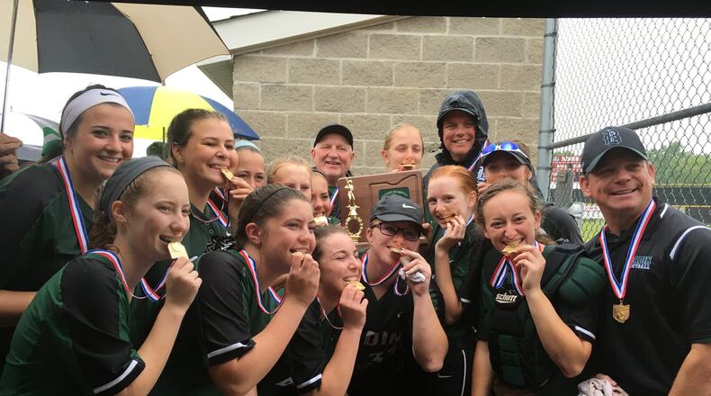 Badin High School’s softball team celebrates with its hardware Friday after defeating Roger Bacon 9-2 in a Division III district championship game at Kings. RICK CASSANO/STAFF