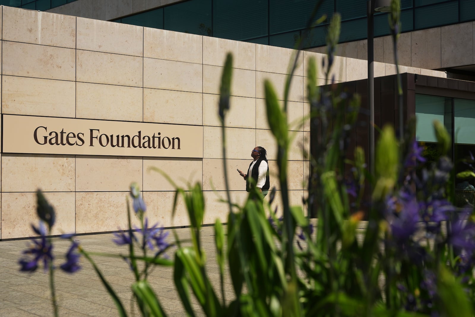 A person walks outside of the Gates Foundation campus Wednesday, April 30, 2025, in Seattle. (AP Photo/Lindsey Wasson)
