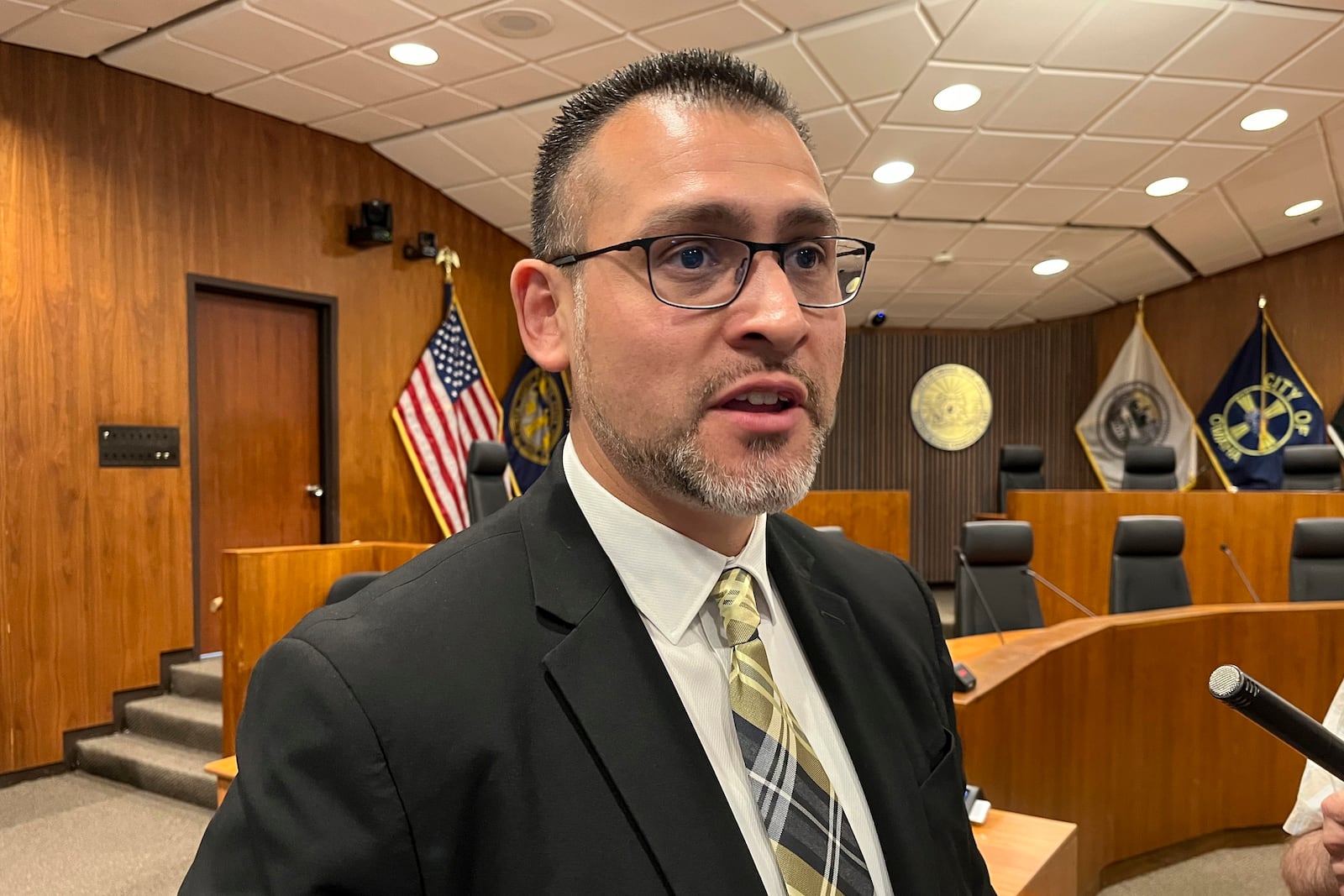 Douglas County Board Chairman Roger Garcia, whose district includes the south Omaha area where federal immigration officials raided a meat packaging plant on Tuesday, June 10, 2025, addresses reporters on Wednesday, June 11, in Omaha, Neb. Garcia says his community, which includes a large immigrant population, is shaken by the raid, and noted that his wife's aunt was among those arrested and taken away from Glenn Valley Foods. (AP Photo/Margery Beck)