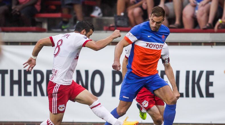 FC Cincinnati lost to New York Red Bulls 3-2 in overtime of their 2017 Lamar Hunt U.S. Open Cup semifinal game Tuesday, Aug. 15 at Nippert Stadium on the University of Cincinnati Campus in Cincinnati. FC Cincinnati midfielder Matt Bahner dribbles in front of New York Red Bulls’ Felipe during the game. NICK GRAHAM/STAFF