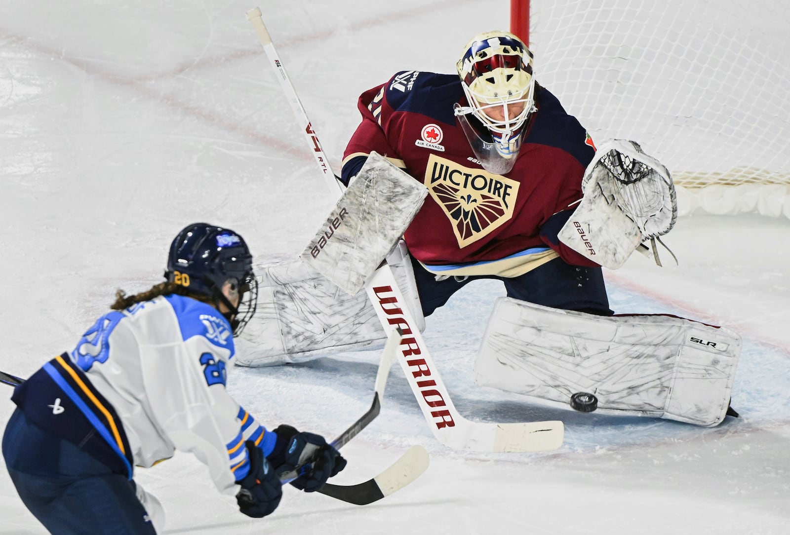 FILE - Montreal Victoire goaltender Elaine Chuli, right, stops Toronto Sceptres' Sarah Nurse (20) during third-period PWHL hockey game action in Laval, Quebec, Sunday, March 23, 2025. (Graham Hughes/The Canadian Press via AP, File)