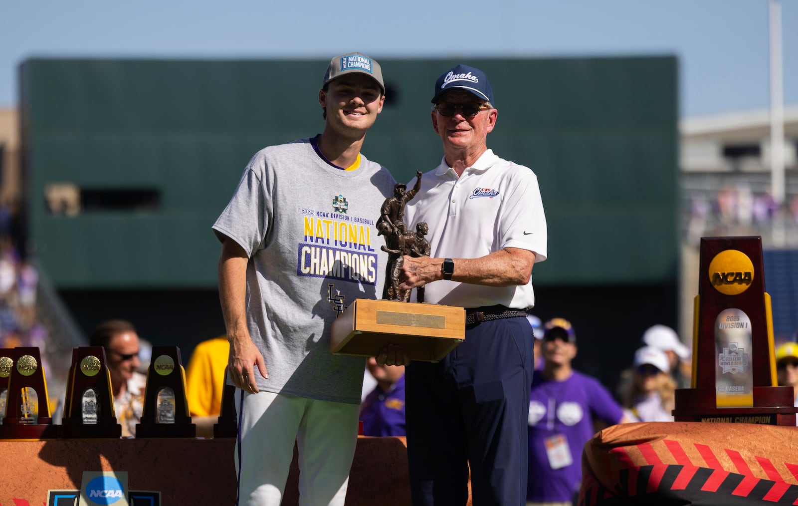 Jack Diesing, Jr., right, presents the John Diesing, Sr., Most Outstanding Player award to LSU pitcher Kade Anderson following their win against Coastal Carolina in Game 2 of the NCAA College World Series baseball finals in Omaha, Neb., Sunday, June 22, 2025. (AP Photo/Rebecca S. Gratz)