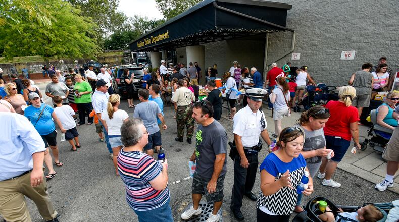 Hamilton’s Police Open House will be from 6 to 8 p.m. Aug. 10 at police department headquarters, 331 S. Front St. The event will feature free food, department tours, an opportunity to explore various vehicles and pieces of equipment, inflatables for children, and face painting. Pictured are residents enjoying the 2016 Police Open House. NICK GRAHAM/STAFF