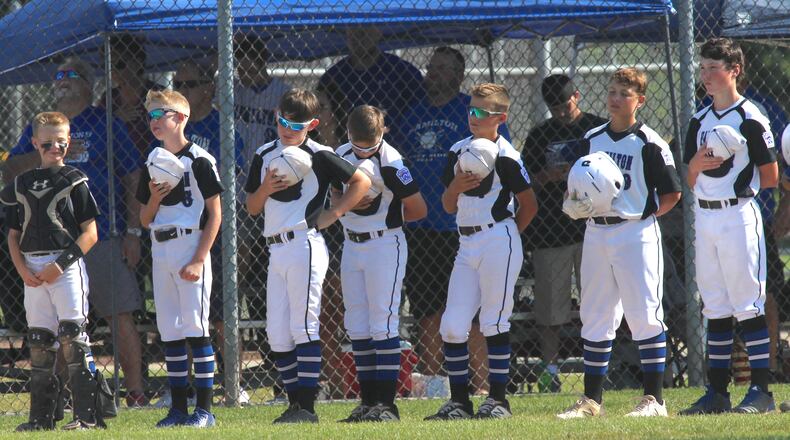 Hamilton West Side players stand for the national anthem before a game against Galion in the Little League state tournament on July 27, 2019, in New Albany. David Jablonski/Staff