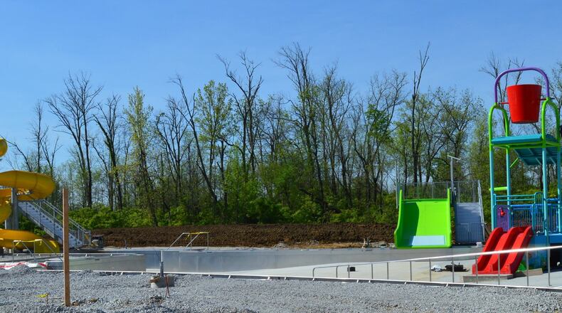 The new Oxford Aquatic Center pool will have three slides. The red one at the right is for young children. The green one in the center is a family slide where several people can go down together. The yellow twisting slide at the left is expected to be popular but to use it, patrons must be 48-inches tall or more. CONTRIBUTED/BOB RATTERMAN