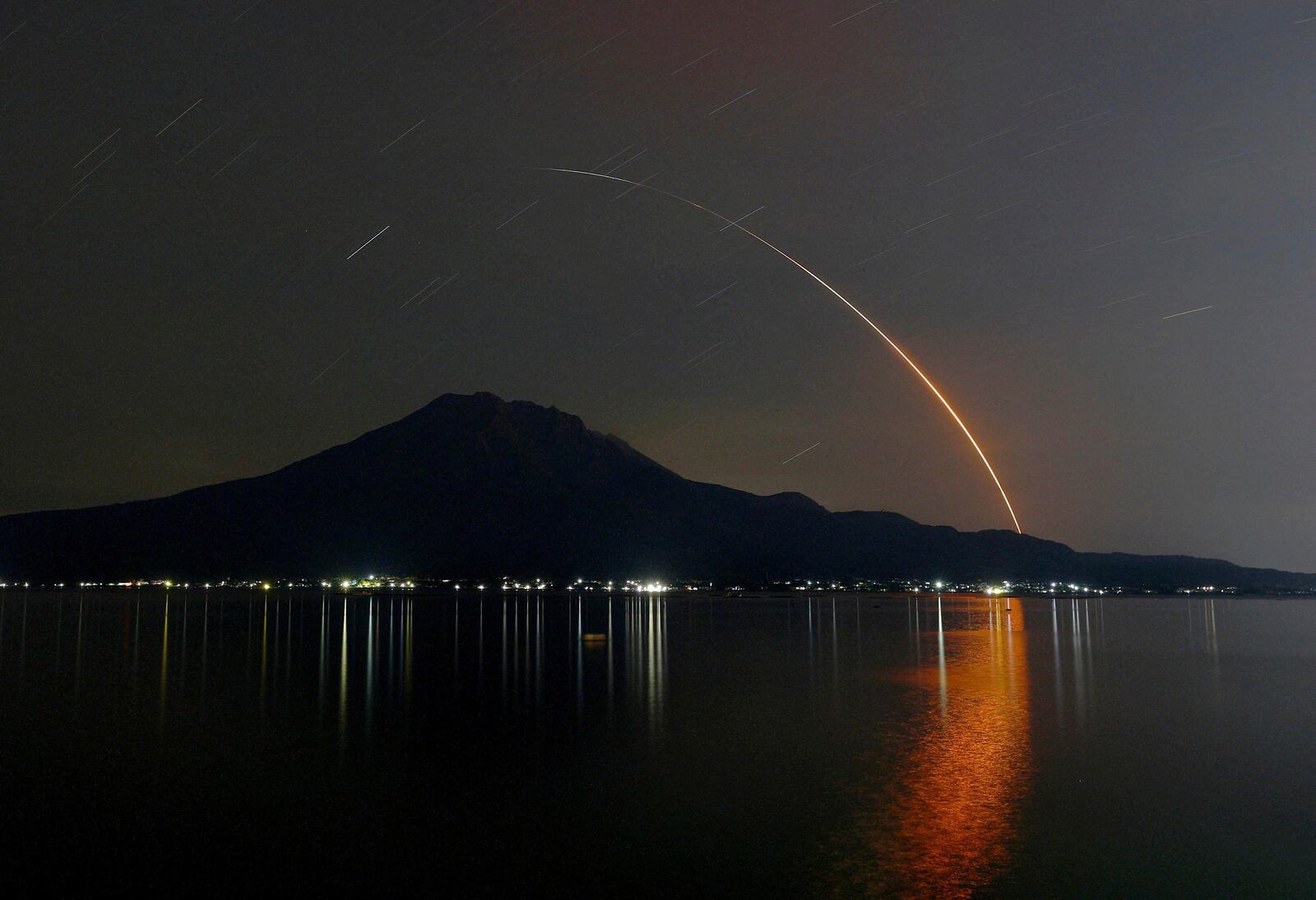 In this long exposure photo, an H-2A rocket carrying Global Observing SATellite for Greenhouse gases and Water cycle, or GOSAT-GW satellite, lifts off from Tanegashima Space Center, seen in Kagoshima, southern Japan, early Sunday, June 29, 2025. (Kotaro Ueda/Kyodo News via AP)