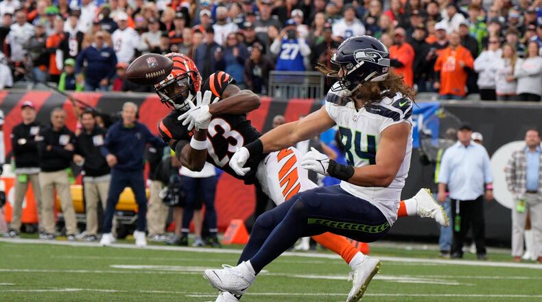 Cincinnati Bengals' Dax Hill (23) breaks up a pass intended for Seattle Seahawks' Dareke Young during the second half of an NFL football game, Sunday, Oct. 15, 2023, in Cincinnati. (AP Photo/Jeff Dean)