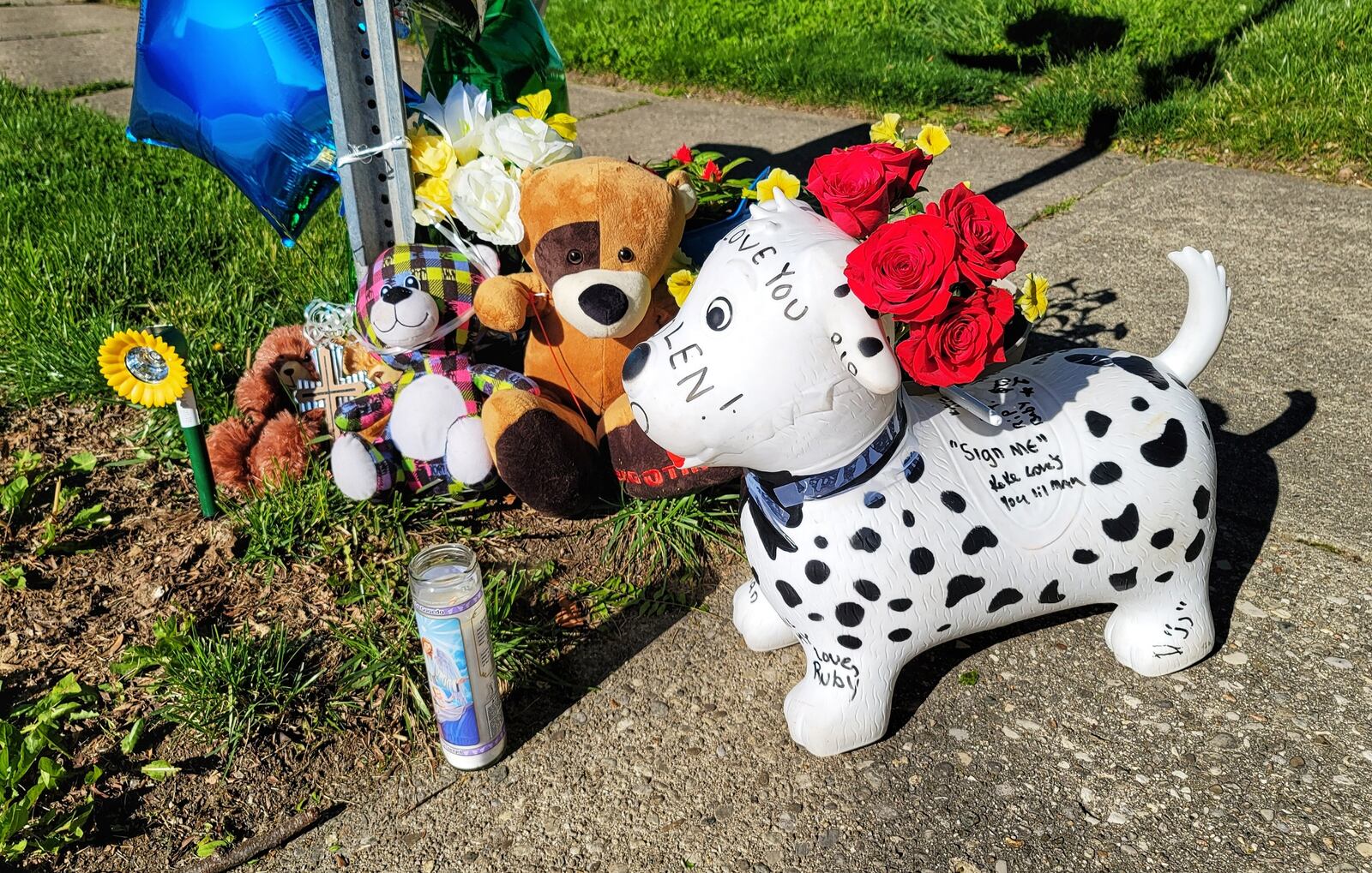A memorial is growing on Pleasant Avenue in Hamilton's Lindenwald neighborhood where a 6-year-old boy was struck by a car and killed Tuesday night. NICK GRAHAM/STAFF