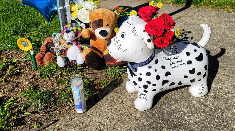 A memorial is growing on Pleasant Avenue in Hamilton's Lindenwald neighborhood where a 6-year-old boy was struck by a car and killed Tuesday night. NICK GRAHAM/STAFF