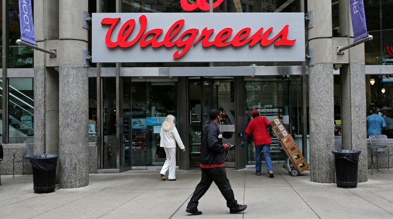 FILE - This June 4, 2014, file photo, shows a Walgreens retail store in Boston. Walgreens and Rite Aid will sell 865 stores to rival retailer Fred’s for $950 million, possibly removing the final roadblock preventing the tie up between the nation’s largest and third-largest drugstore chains, in news announced Tuesday, Dec. 20, 2016. (AP Photo/Charles Krupa, File)
