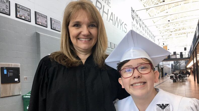 Recent Lakota East High School graduate Amelia Murphy has overcome a lot after being born with spina bifida, but thanks to her 12-year bond with a dedicated learning assistant Pat Burley (left) she wasn t alone in her battles.