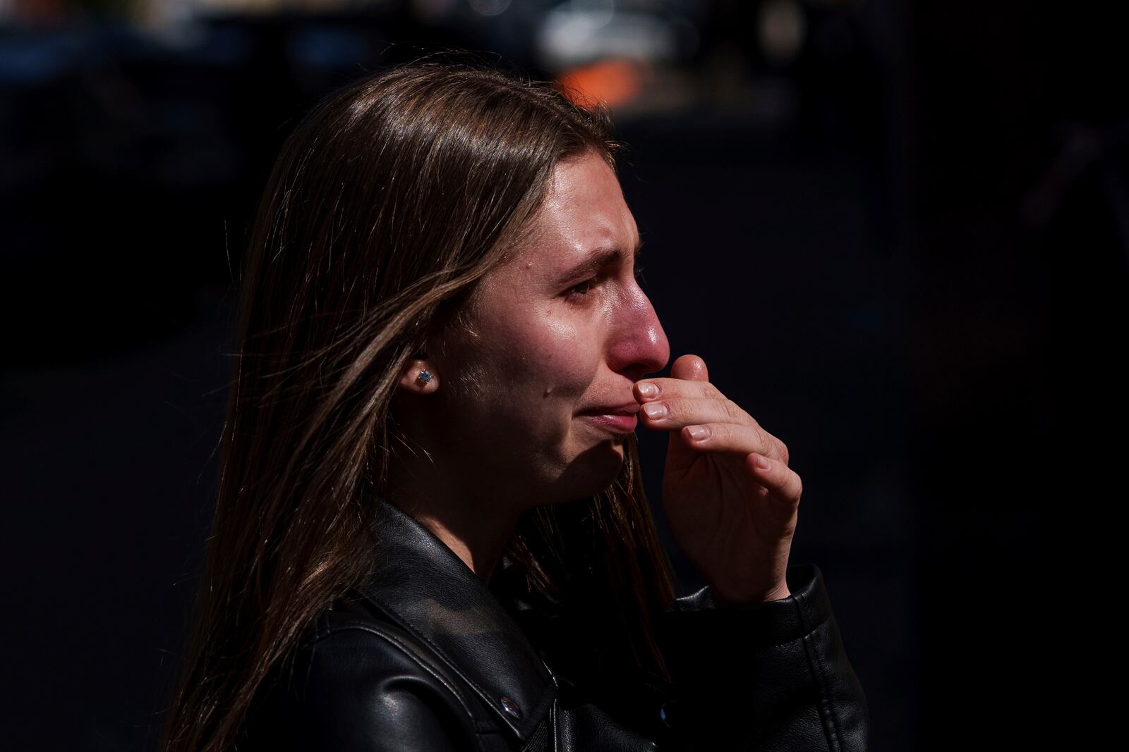 Kateryna Sitak, 23, a teacher, cries after laying flowers and toys on a site of a Russian missile strike in Sumy, Ukraine, Monday, April 14, 2025. (AP Photo/Evgeniy Maloletka)