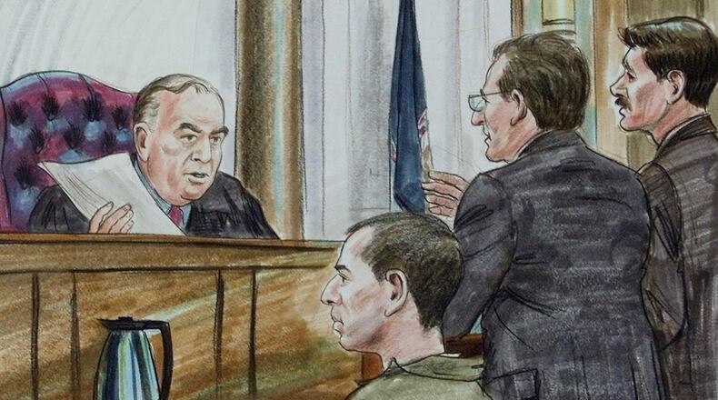 FILE - In this courtroom sketch, U.S. District Judge T.S. Ellis III, left, presides during a hearing for captured American Taliban John Walker Lindh, seated, on Feb. 15, 2002, in Alexandria, Va. Ellis, who oversaw numerous high-profile trials, died Wednesday, July 30, 2025, after a long illness at the age of 85. (AP Photo/Arthur Lien, File)