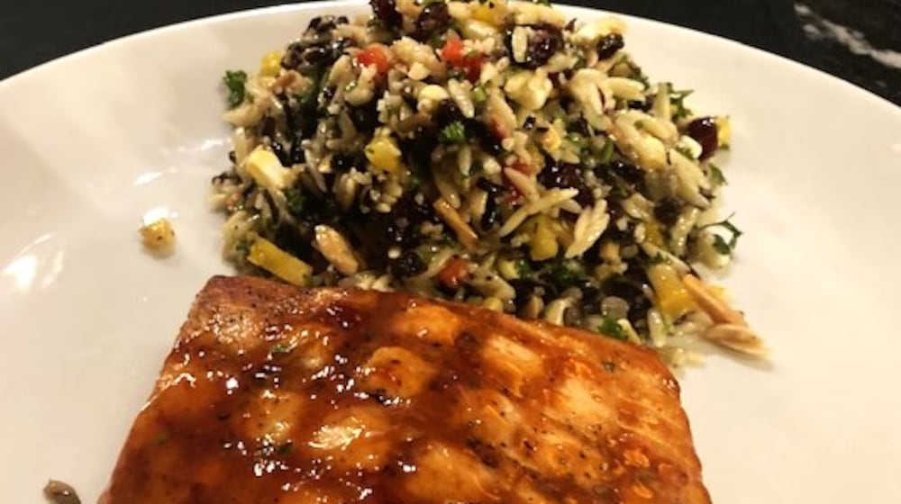 The Thai barbecue-glazed salmon with orzo and wild rice at J. Alexander's in Dayton has flavorful orzo with almond slivers, red winter wheat, cranberries, corn, currants, and other ingredients. RAY MARCANO/CONTRIBUTED