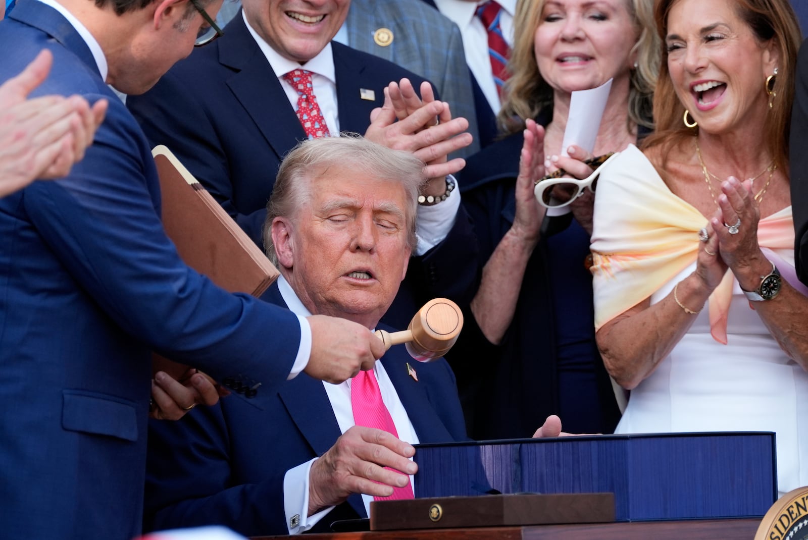 House Speaker Mike Johnson, r-La., hands President Donald Trump a gavel after Trump signed his signature bill of tax breaks and spending cuts at the White House in Washington, Friday, July 4, 2025.(AP Photo/Alex Brandon, Pool)