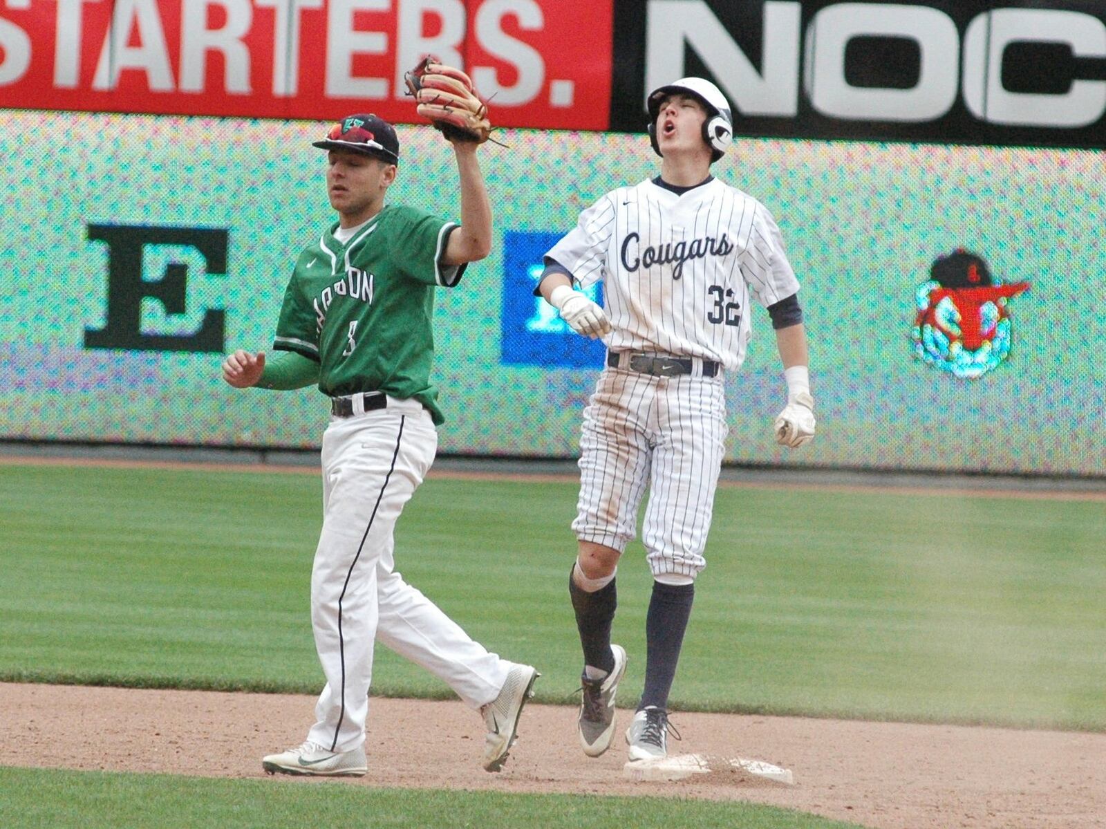 Edgewood’s Conner Beckman (32) reacts to being called out at second base after a tag by Harrison’s Coby Campbell on Saturday at Great American Ball Park in Cincinnati. Edgewood won 2-1 in a Southwest Ohio Conference baseball game that was part of the Skyline Chili Reds Futures High School Showcase. RICK CASSANO/STAFF