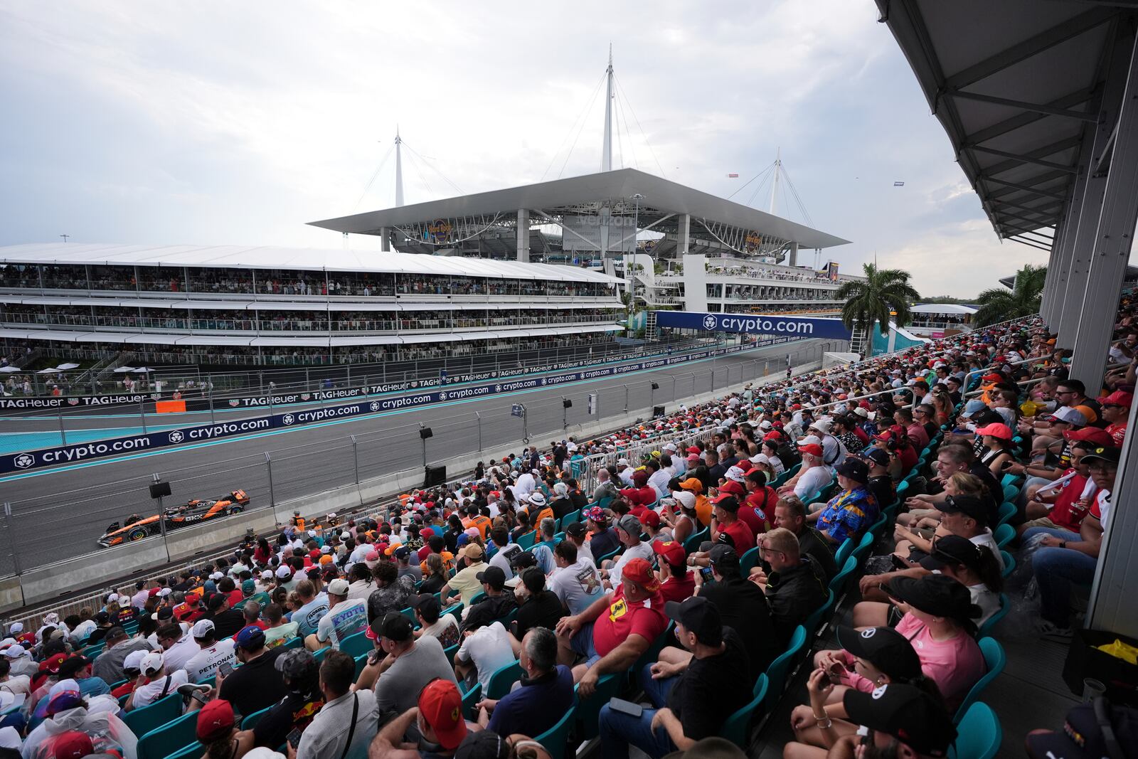 Fans watch McLaren driver Oscar Piastri of Australia race past during the Formula One Miami Grand Prix auto race Sunday, May 4, 2025, in Miami Gardens. Fla. (AP Photo/Rebecca Blackwell)