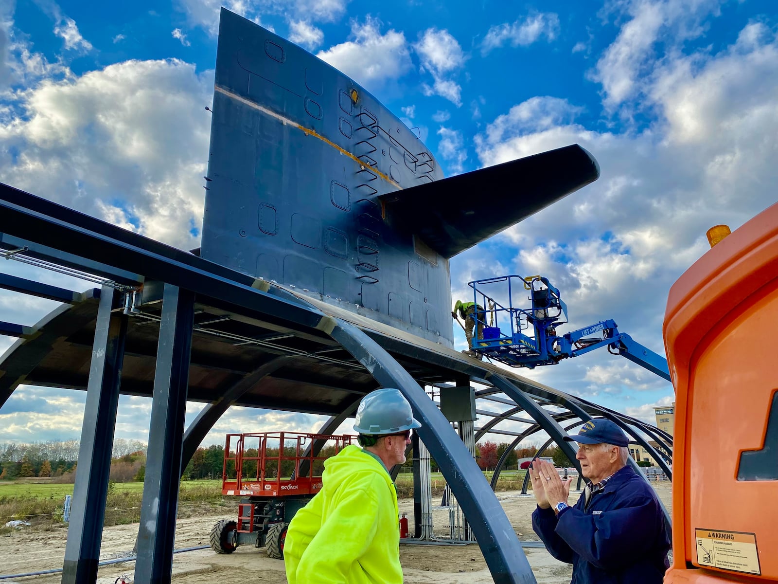 Bob Viney (right), vice president & program executive of the Submarine Cincinnati Memorial Association, discusses memorial site with construction official. The Cold War memorial is scheduled to open in May 2026. (Photo By Michael D. Clark/Journal-News)