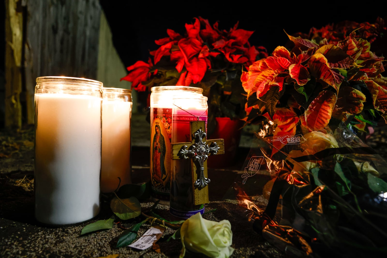 Flowers and candles were left near the intersection of River Road and Hooven Avenue on Sunday, Dec. 21, 2025. The area was the site of a crash that killed three people earlier in the day. NICK GRAHAM / STAFF