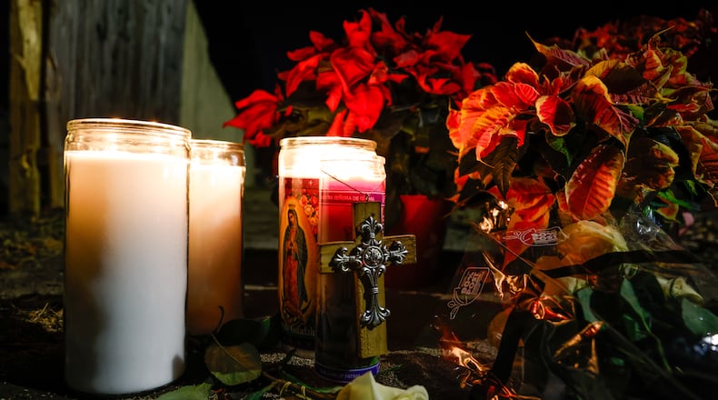 Flowers and candles were left near the intersection of River Road and Hooven Avenue on Sunday, Dec. 21, 2025. The area was the site of a crash that killed three people earlier in the day. NICK GRAHAM / STAFF