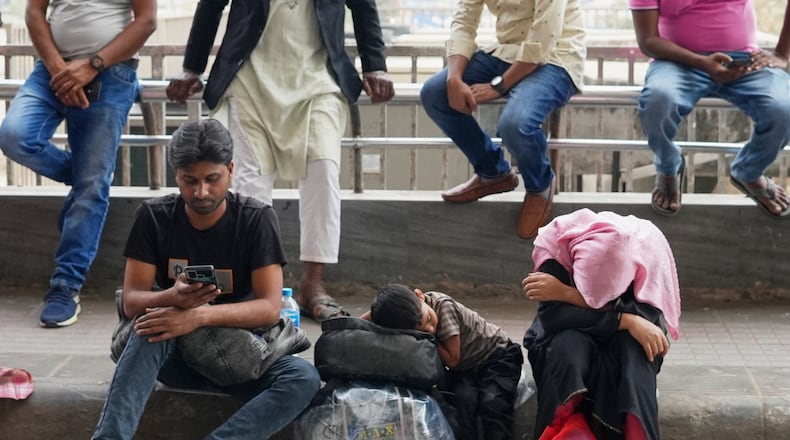 Passengers wait at the Hazrat Shahjalal International Airport after several flights were cancelled or delayed due to the US-Israeli attack on Iran, in Dhaka, Bangladesh, Sunday, March 1, 2026. (AP Photo/Al-emrun Garjon)