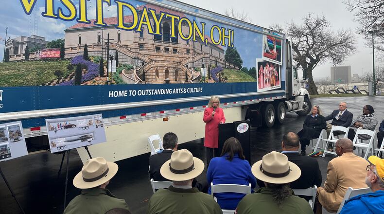 Jacquelyn Powell, president and CEO of the Dayton Convention & Visitors Bureau, speaks at an event where the third semi-trailer with images promoting Dayton was unveiled. The truck is likely to travel about 100,000 miles all over the country each year. CORNELIUS FROLIK / STAFF