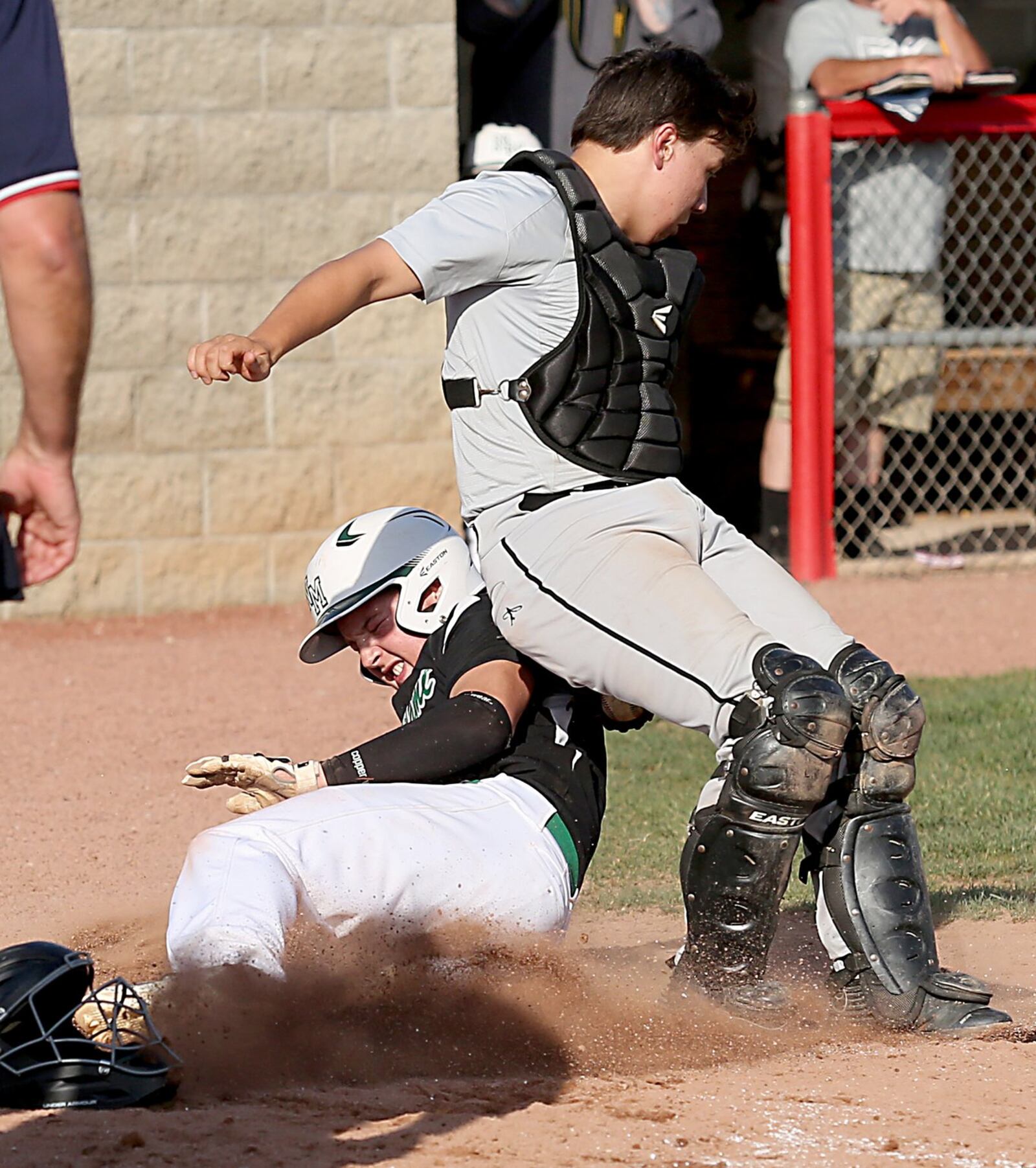 New Miami’s Ronnie Bowman is tagged out at home plate by Miami Valley Christian Academy catcher Seth Henderson during their Division IV sectional final at Kings on Wednesday. CONTRIBUTED PHOTO BY E.L. HUBBARD