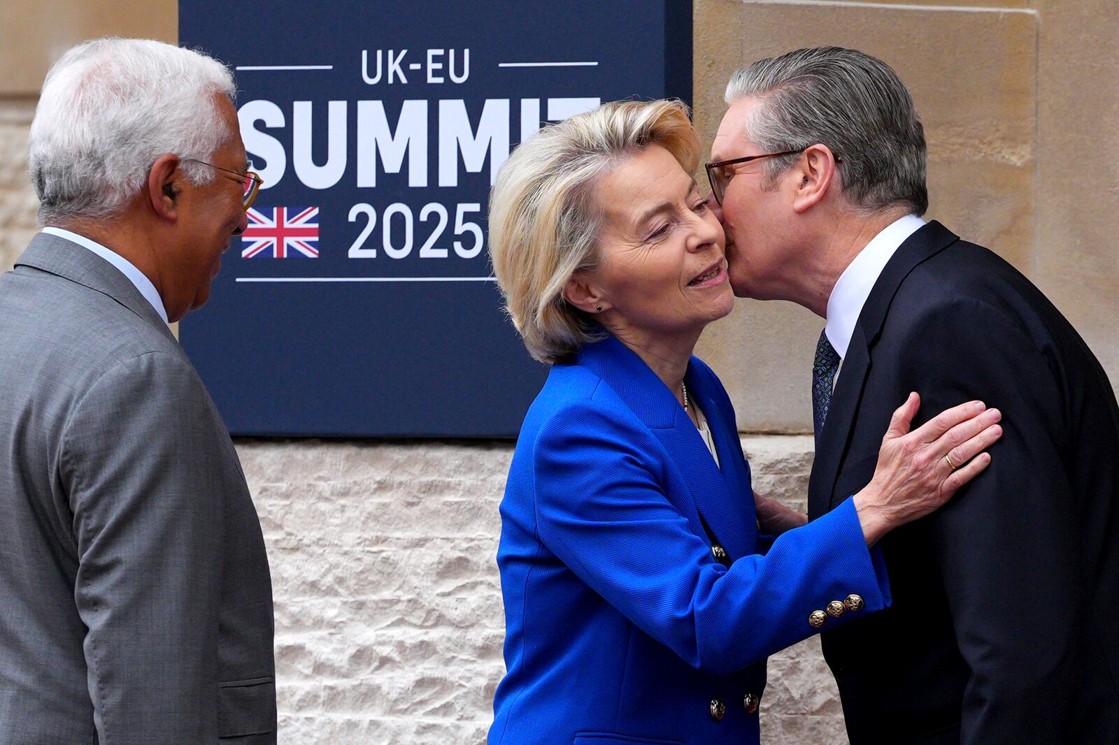 Britain's Prime Minister Keir Starmer, right, kisses European Commission President Ursula von der Leyen as she arrives with European Council President Antonio Costa to attend a United Kingdom and European Union summit at Lancaster House, London, Monday, May 19, 2025. (Carl Court/Pool Photo via AP)