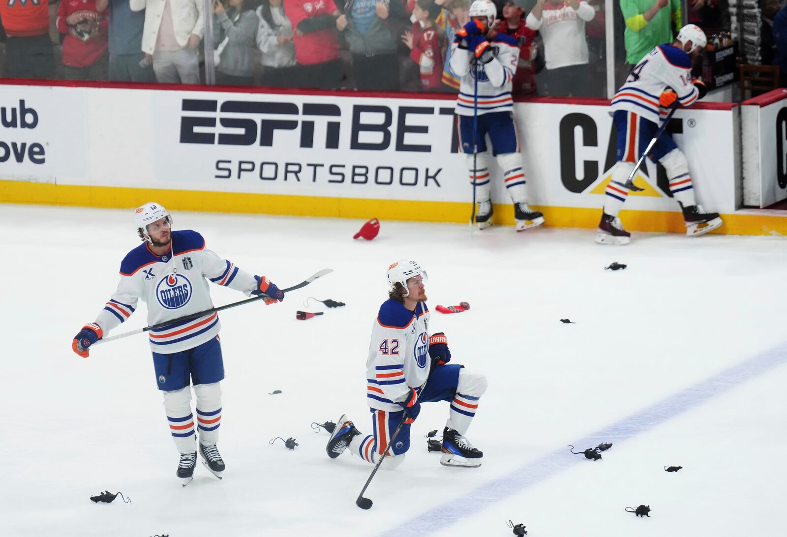 Edmonton Oilers' Mattias Janmark (13) and Kasperi Kapanen (42) look on as the Florida Panthers celebrate after winning Game 6 of the NHL hockey Stanley Cup Final in Sunrise, Fla., Tuesday, June 17, 2025. (Nathan Denette/The Canadian Press via AP)