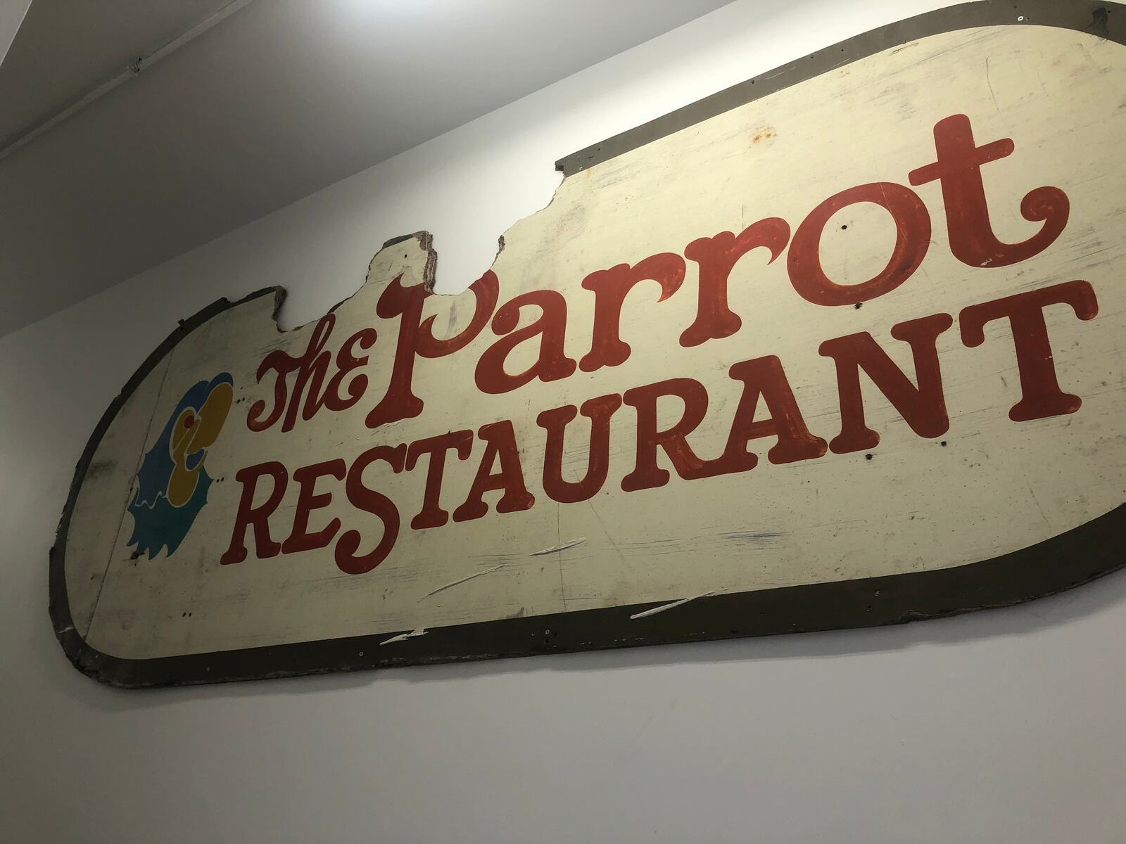 The original Parrot Restaurant sign greets residents as they enter the back door of the building at 1044 Central Ave. in downtown Middletown. The restaurant was located in the former City Centre Mall. RICK McCRABB/STAFF