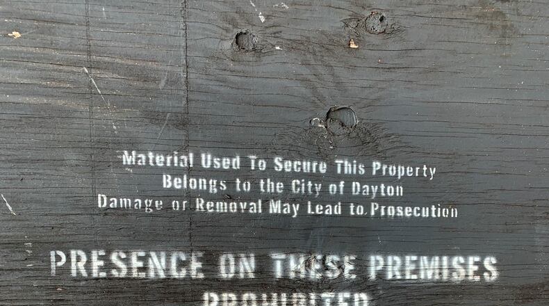 A sign over the garage of a home on Wheatley Avenue says presence is prohibited. The owner of the home received $11,500 last year through a rental assistance program funded with federal CARES Act money. The property did not have water last year.