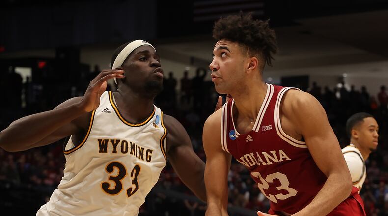 Indiana's Trayce Jackson-Davis puts is defended by Wyoming's Graham Ike during Tuesday's First Four game at UD Arena. BILL LACKEY/STAFF