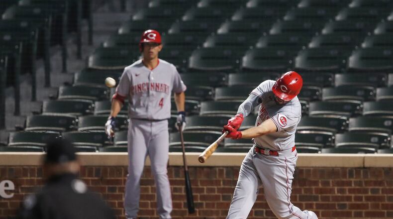 Cincinnati Reds' Mike Moustakas (9) hits three-run home run against the Chicago Cubs during the first inning of a baseball game Wednesday, Sept. 9, 2020, in Chicago. (AP Photo/Kamil Krzaczynski)