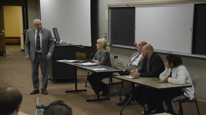 Butler County Prosecutor Mike Gmoser (standing) addresses an Ohio State University student during a panel discussion on Ohio Issue 1 at Miami University Regionals in Hamilton.