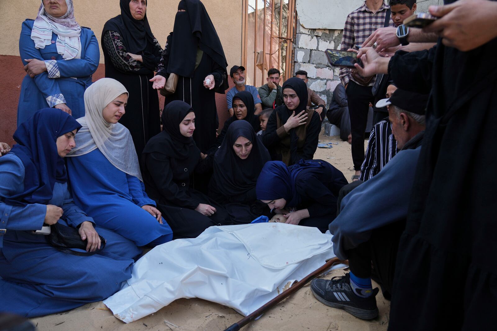 Palestinians mourn over the body of Kinan Edwan, 2 years old, killed in an Israeli army airstrike, during his funeral in Khan Younis, southern Gaza Strip, Saturday, April 19, 2025. (AP Photo/Abdel Kareem Hana)