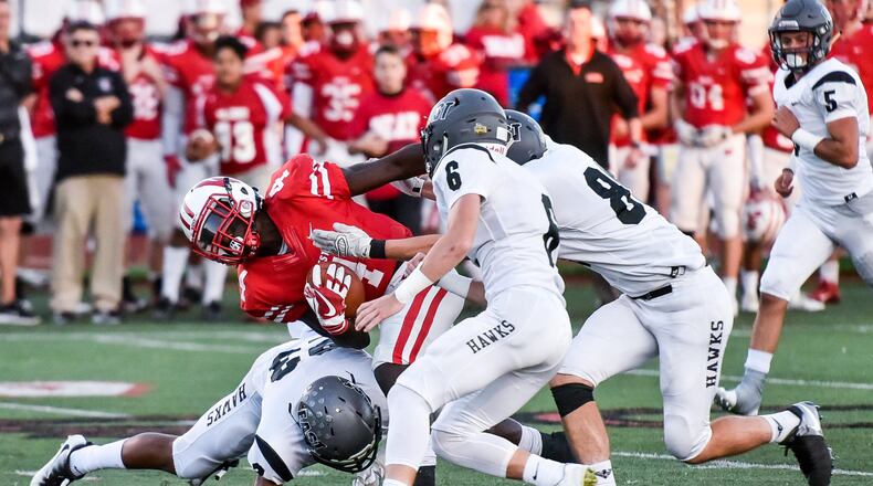 Lakota East’s Avi McGary (23) and Jackson Leahy (6) are among the players tackling Lakota West’s David Afari during a Sept. 29 game in West Chester Township. East won 35-0. NICK GRAHAM/STAFF
