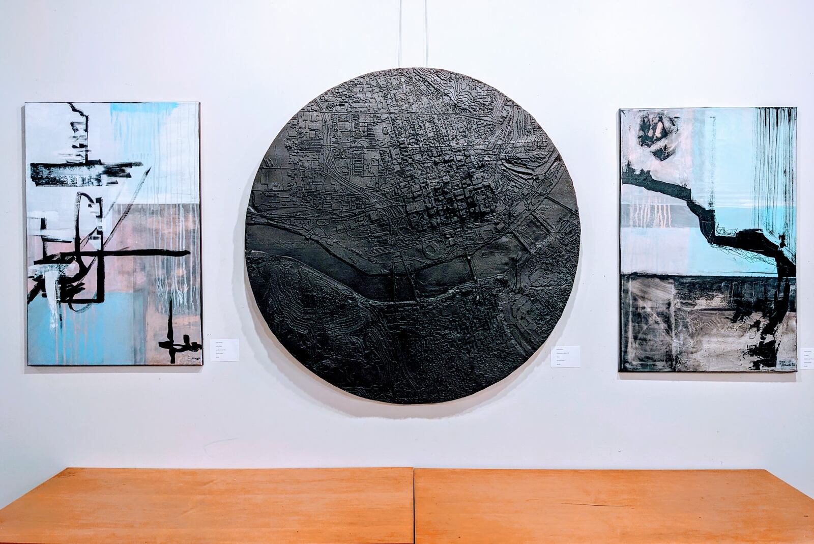 David Falter’s piece in the "Beautiful Imagination" exhibit at The Strauss Gallery is three-dimensional. It’s a big circle, all black, and it’s like a miniature molding of the city. CONTRIBUTED