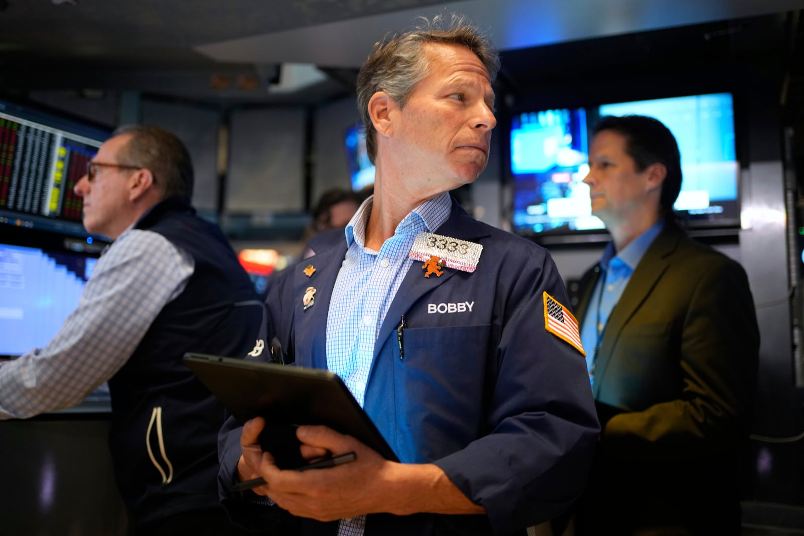 Bobby Charmak, center, works on the floor at the New York Stock Exchange in New York, Wednesday, April 30, 2025. (AP Photo/Seth Wenig)