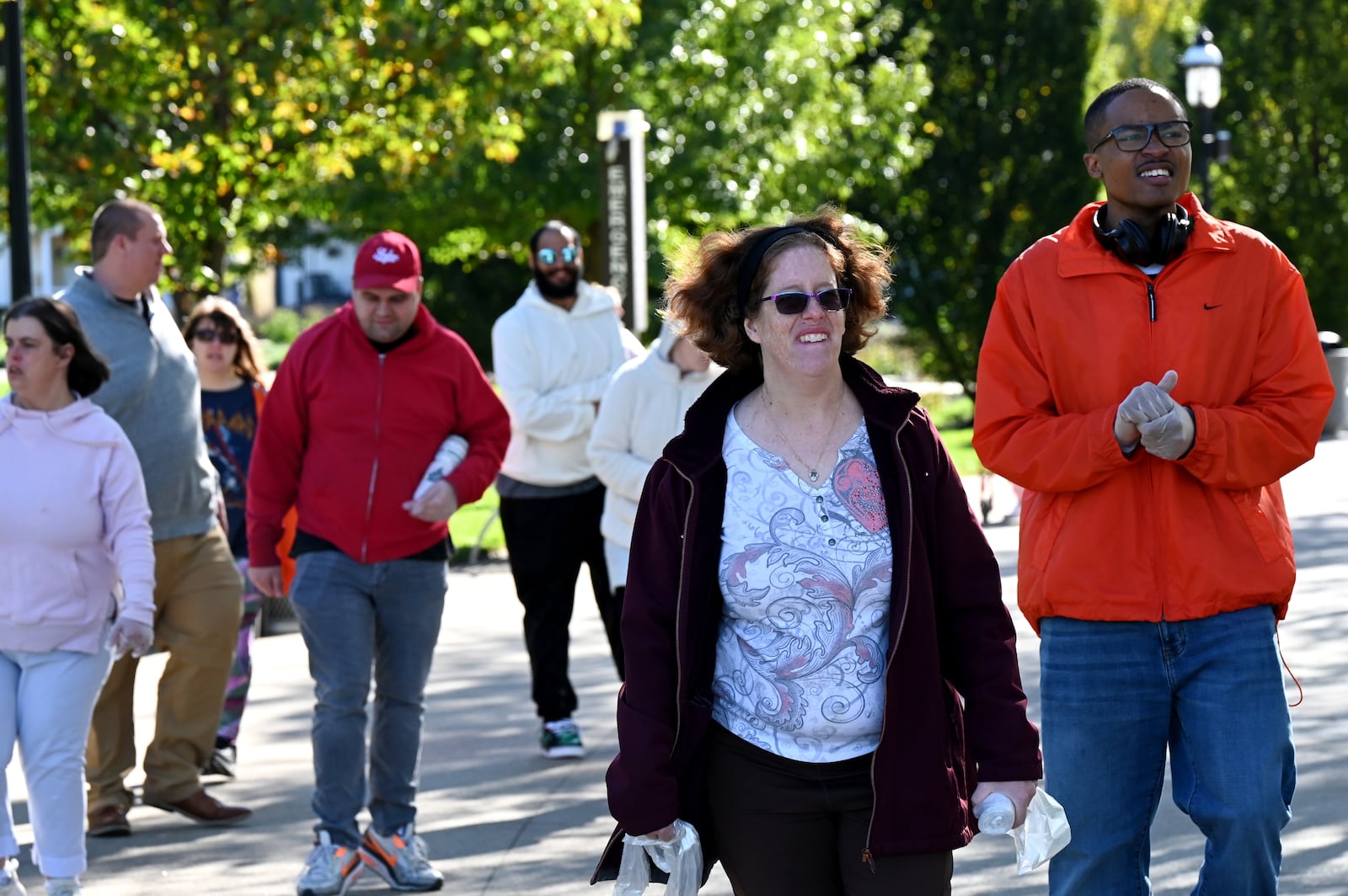 The Hamilton Parks Conservancy District initiated a pilot Adopt-a-Park program this year with Inspiration Studios and is rolling it out to the community, inviting organizations and businesses to adopt any one of the city's 42 park properties. Pictured are clients of Inspiration Studios cleaning up part of Marcum Park in German Village on Thursday morning, Oct. 23, 2025. MICHAEL D. PITMAN/STAFF